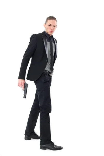 Hombre Guapo Con Traje Negro Una Pistola Posando Sobre Fondo —  Fotos de Stock