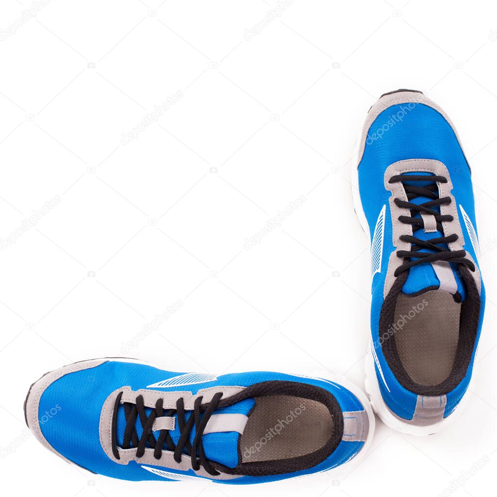 Picture of a pair of blue trainers over a white background