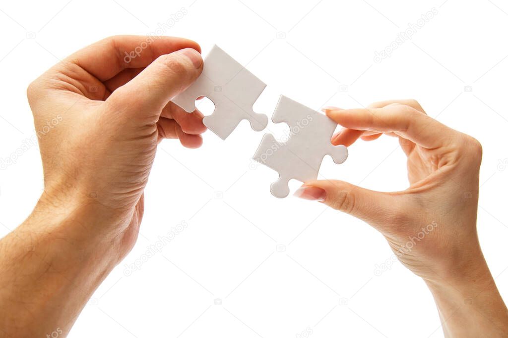 Girl holding white puzzle on a white background