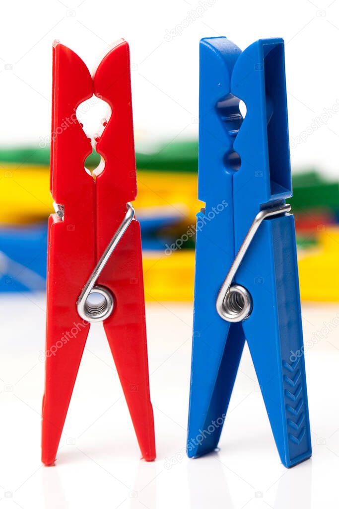 Closeup image of little colorful clothespins on a white background