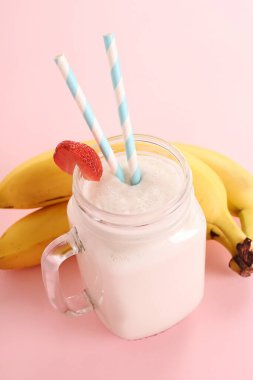 Pembe arka planda lezzetli bir milkshake.