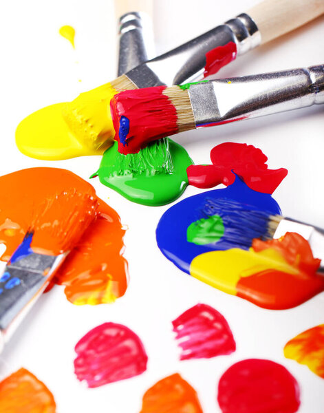 Close up of colorful paint and brushes
