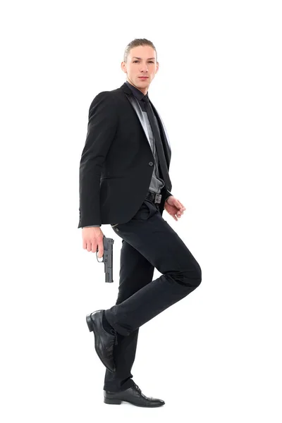 Hombre Guapo Con Traje Negro Una Pistola Posando Sobre Fondo —  Fotos de Stock