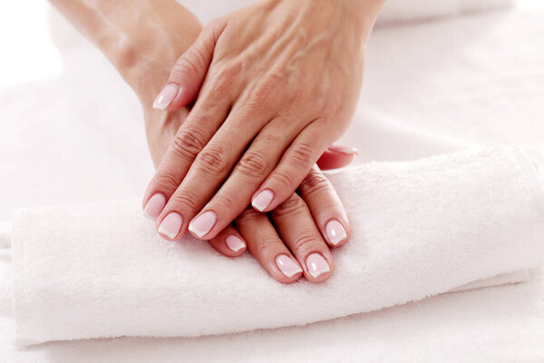 Skincare. Soft and clean hands on a white towel