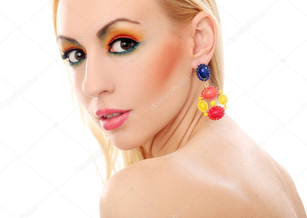Blonde girl with jewelry has colored makeup