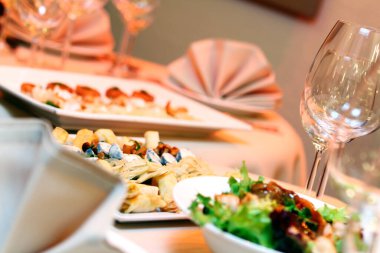 Restoran servisi ve atıştırmalıklarla dolu bir ziyafet masası.