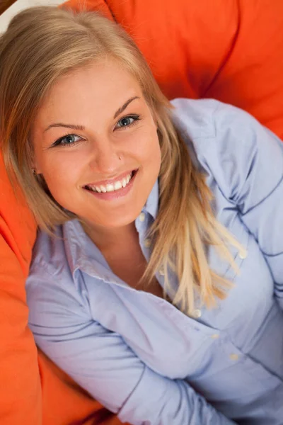 Young Blond Caucasian Woman Smiling Orange Sofa — Stock Photo, Image