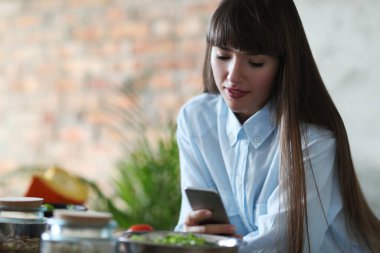 Yemek pişirmek. Kız mutfakta yemek pişiriyor.