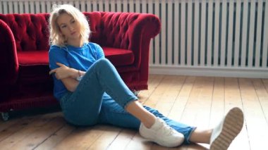 Genç ve güzel bir kadın evde dinleniyor. 