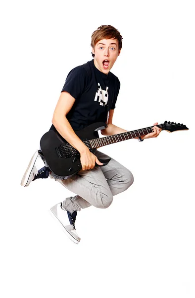 若くて魅力的な少年ジャンプして白で隔離のエレク トリック ギター — ストック写真