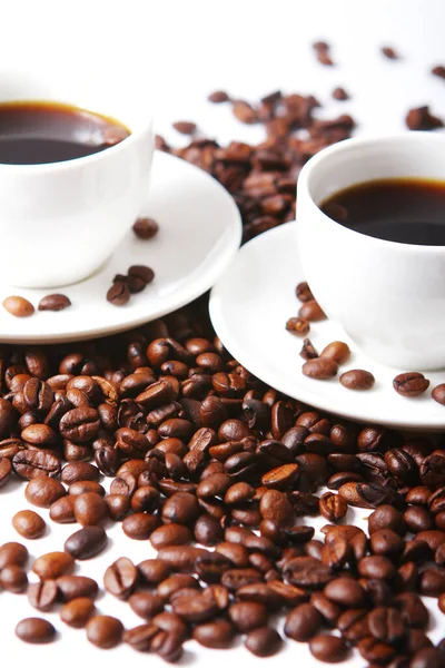 Coffee beans with white cups on the table