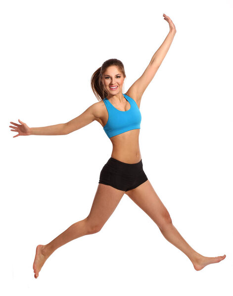 Beautiful active woman in a fitness wear jumping isolated over white background