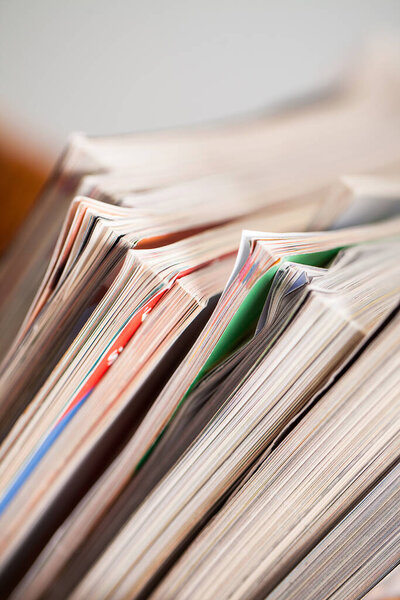 Closeup image of magazines in a straw pleated  box