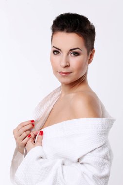 Young woman with short haircut in bathrobe isolated over white background clipart