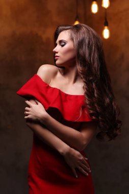 Woman in red dress with gorgeous, curly hairdo