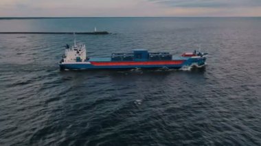 Gün batımında kargo gemisinin deniz manzarası. 