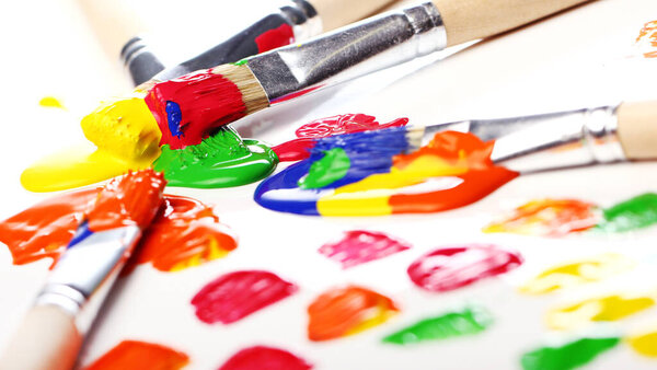 Close up of colorful paint and brushes