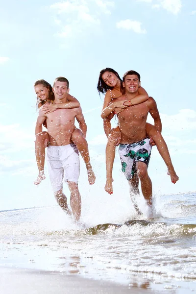 Happy Teenagers Playing Sea Stock Picture