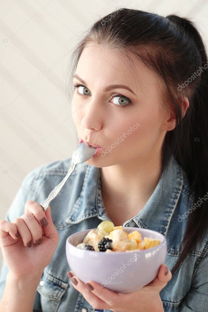 Woman eating breakfast at home