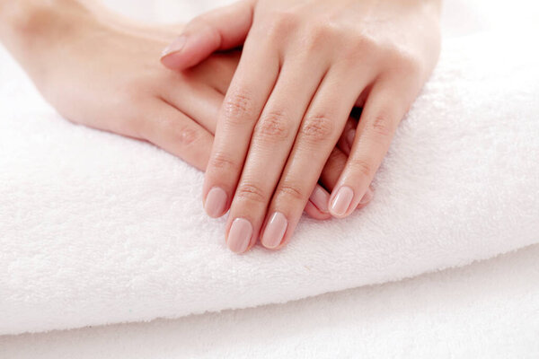 Skincare. Soft and clean hands on a white towel