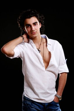 Siyah arka planda izole edilmiş genç ve çekici Latin çocuk.