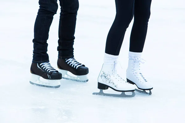 Skates. Couple on the ice rink