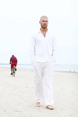 Sahilde çekici ve mutlu bir adam.