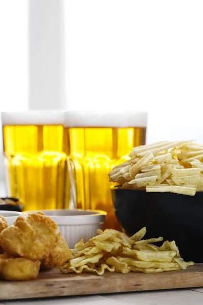 stock image Alcohol and food. Beer with snacks on the table