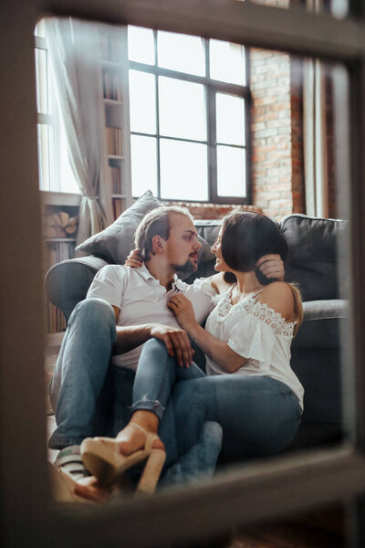 Portrait of beautiful and lovely couple relaxing at home