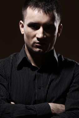 Karanlık arka planda ciddi bir iş adamının portresi