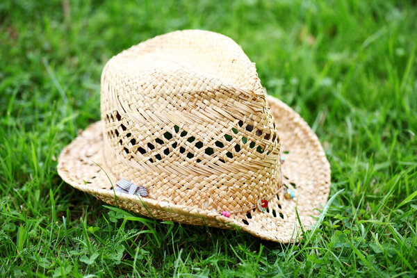 Close up of straw hat on the grass