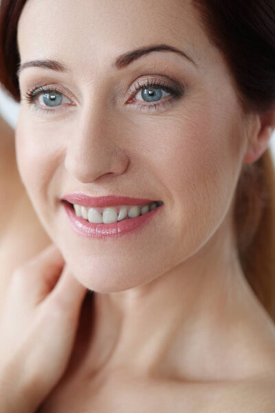 Close-up portrait of beautiful young woman with ginger hair