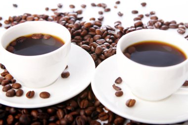 Masada beyaz bardaklı kahve çekirdekleri.