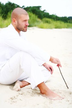 Sahilde çekici ve mutlu bir adam.