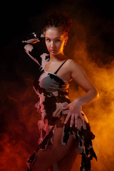 美しい女性がオレンジの煙の背景でサルサダンスを踊る — ストック写真
