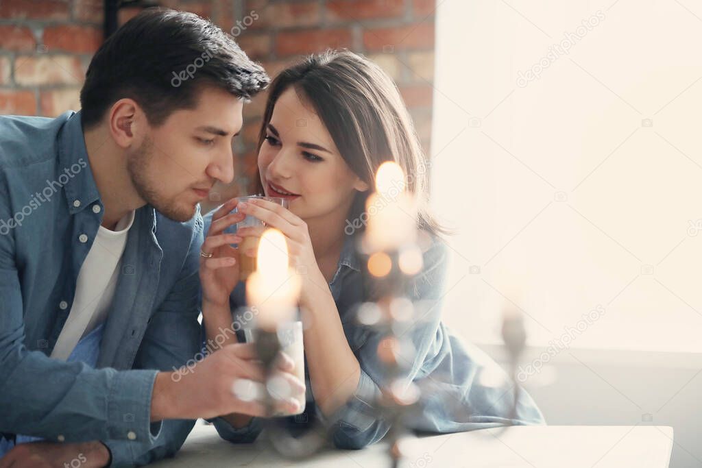 Lovely couple drinking coffee together on the kitchen