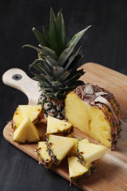 Kesme tahtasında dilimlenmiş ananas.