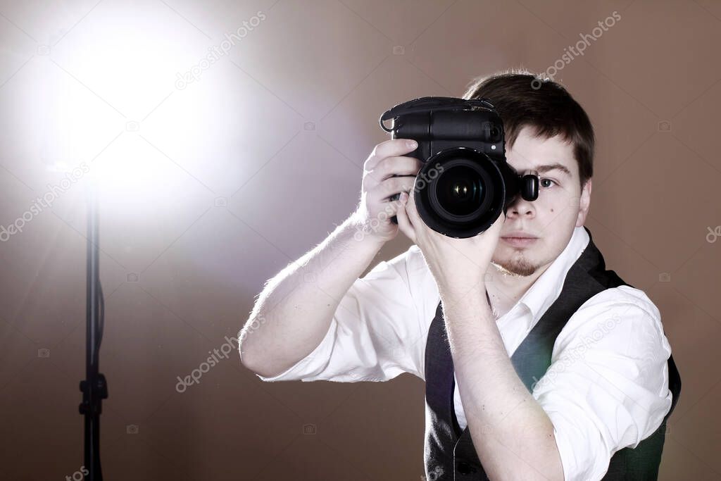 Photographer with camera in studio