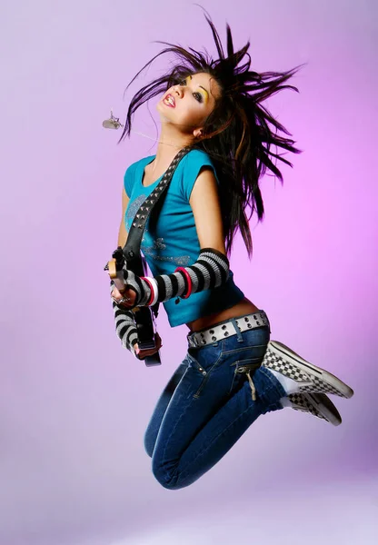 Sexy emo girl with fashion hairstyle posing in studio