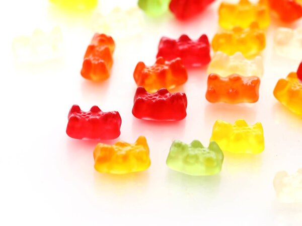 Colorful gummy bear candies over white background