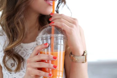 ładny, kręcone kobieta ze soku pomarańczowego