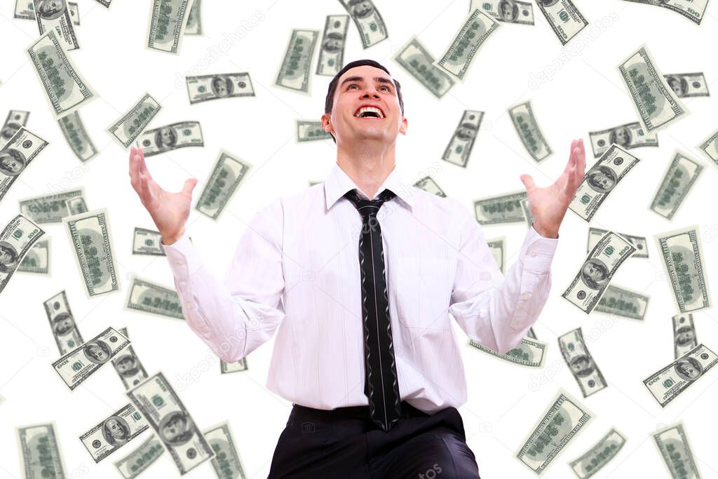 Happy businessman and flying dollar banknotes against white background