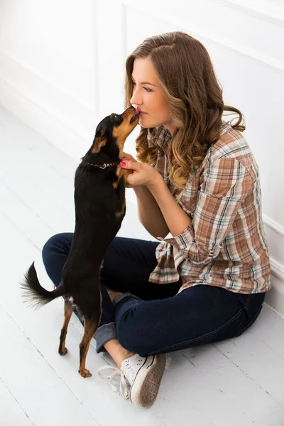 Attractive woman with dog on the floor