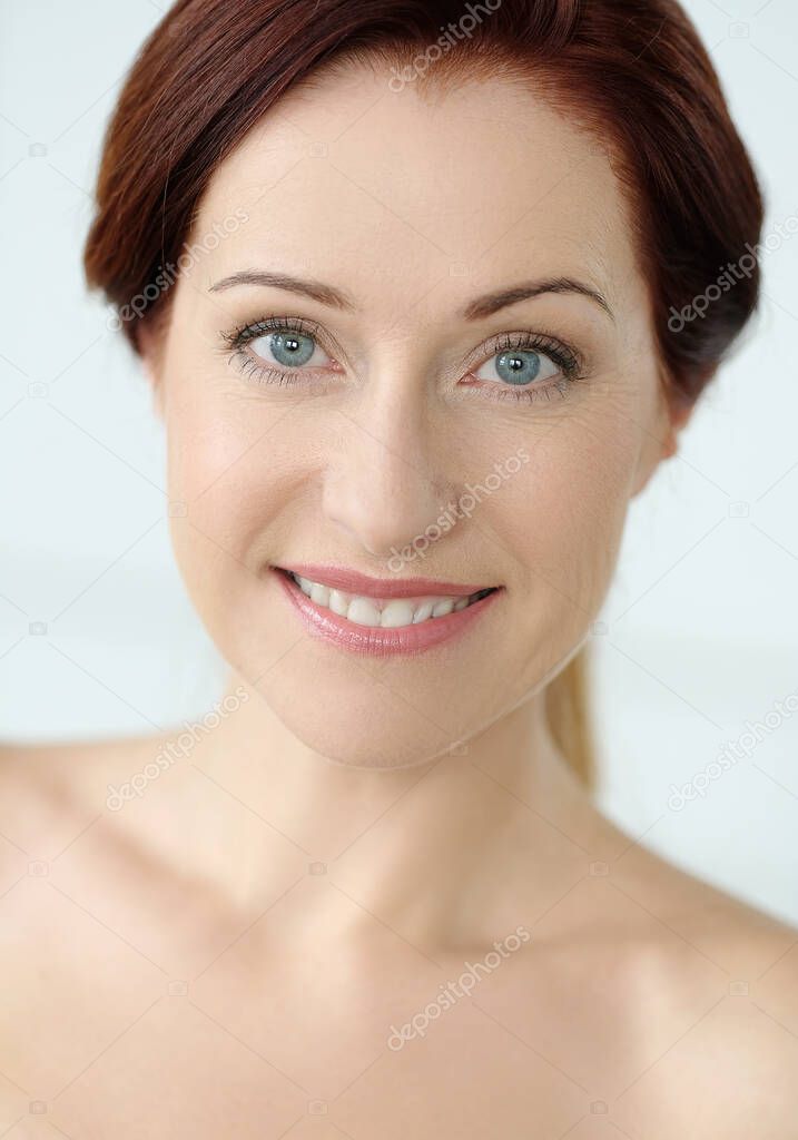 Close-up portrait of beautiful young woman with ginger hair