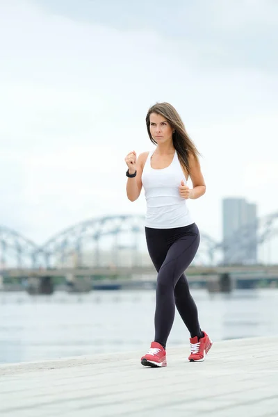 Sport, fitness. Woman is exercising on the street
