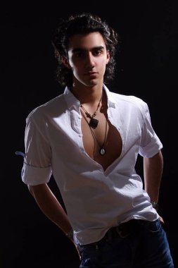 Siyah arka planda izole edilmiş genç ve çekici Latin çocuk.