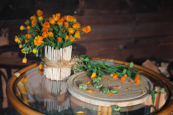 Rustic composition of calendula flowers and flower seed on the small plate — Stock Photo, Image