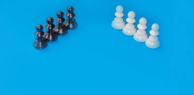 Black and white chess pieces on a blue background. Stop racism. Black lives matter