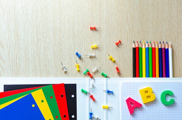 Kleurrijke samenstelling van schoolspullen en brieven op de withe houten achtergrond. Begrepen, ruimte. Plat gelegd. Terug naar schoolconcept. — Stockfoto