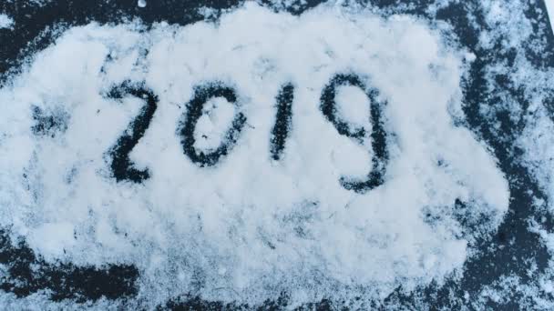 Inscription 2019 on the snow close-up. New Year two thousand and nineteen. — Stock Video